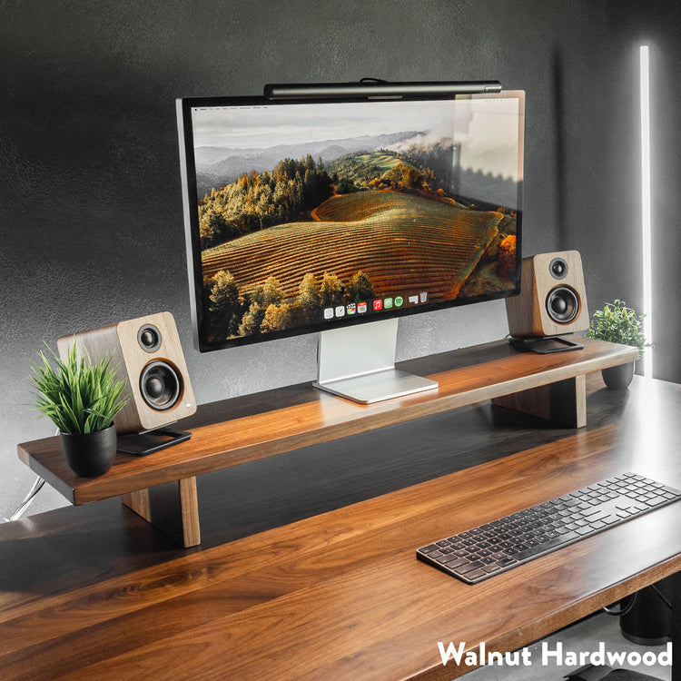 Desky monitor stand setup on desk in walnut hardwood